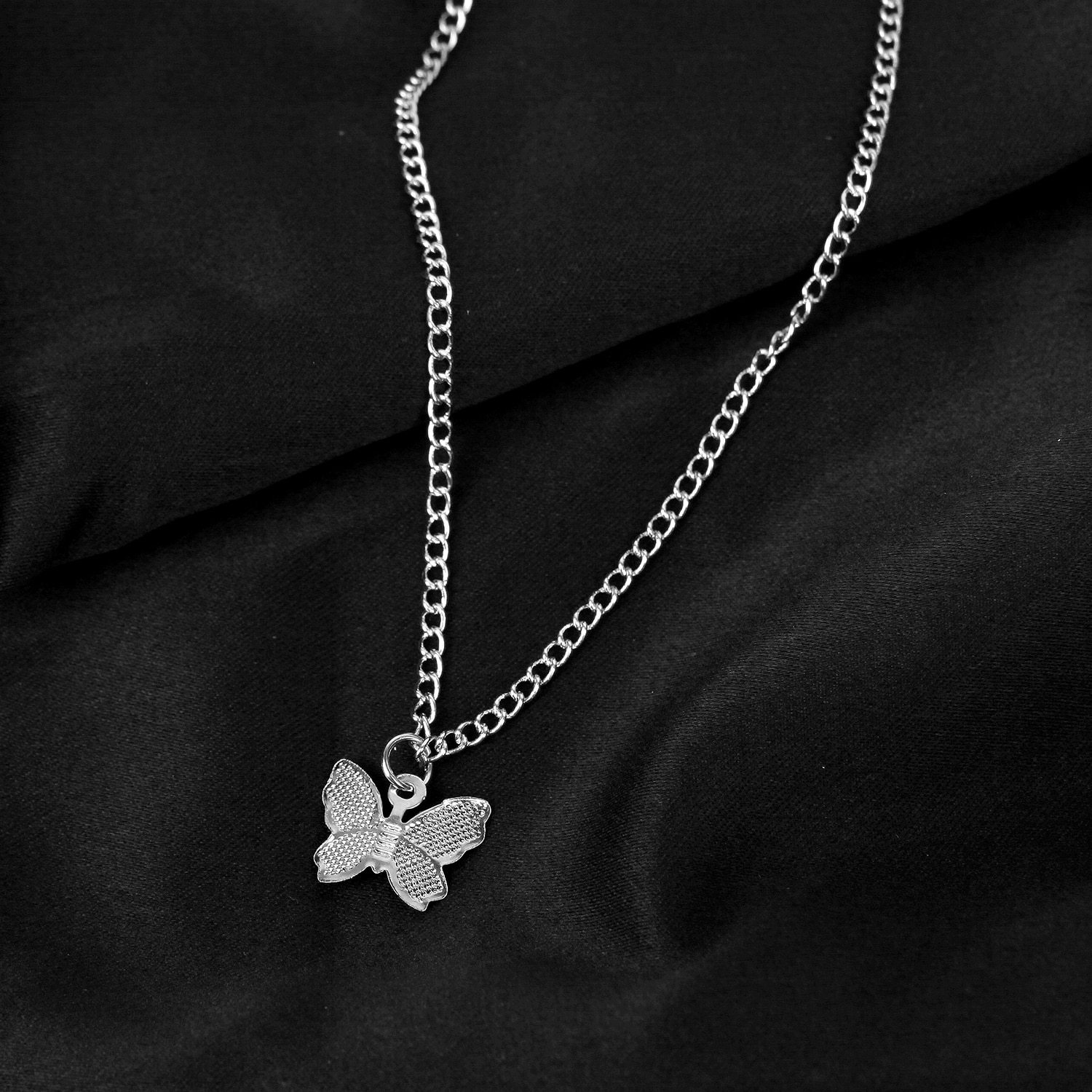A Gold Chain Butterfly Pendant Choker for Women on a black background.