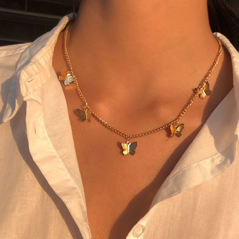 A woman wearing a Gold Chain Butterfly Pendant Choker.
