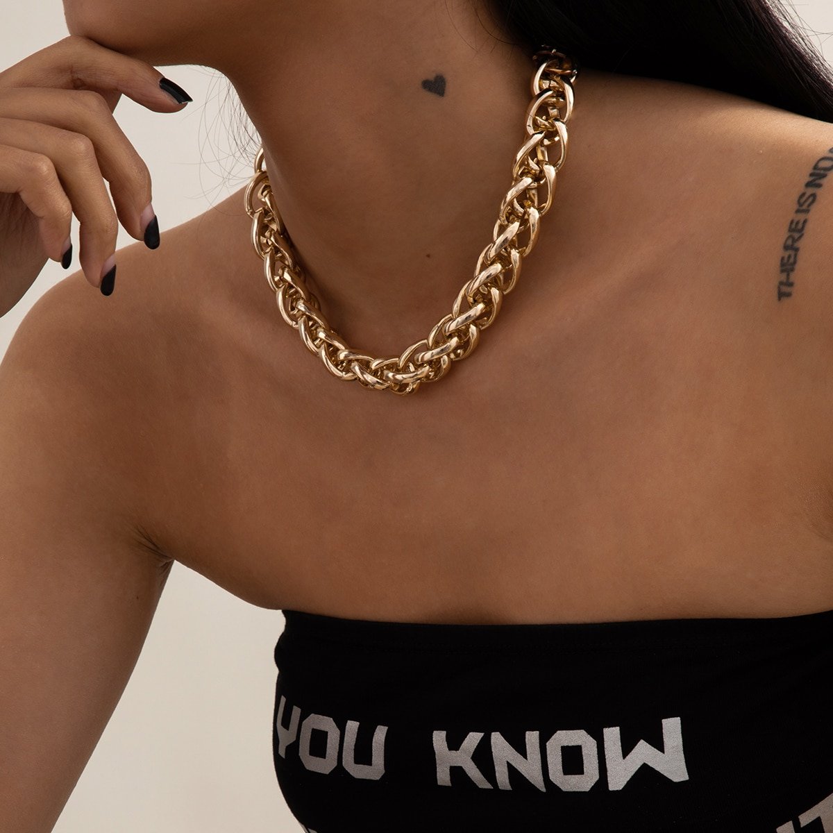 A woman wearing a black tank top and a Stylish Women's Thick Gold Chain Necklace.