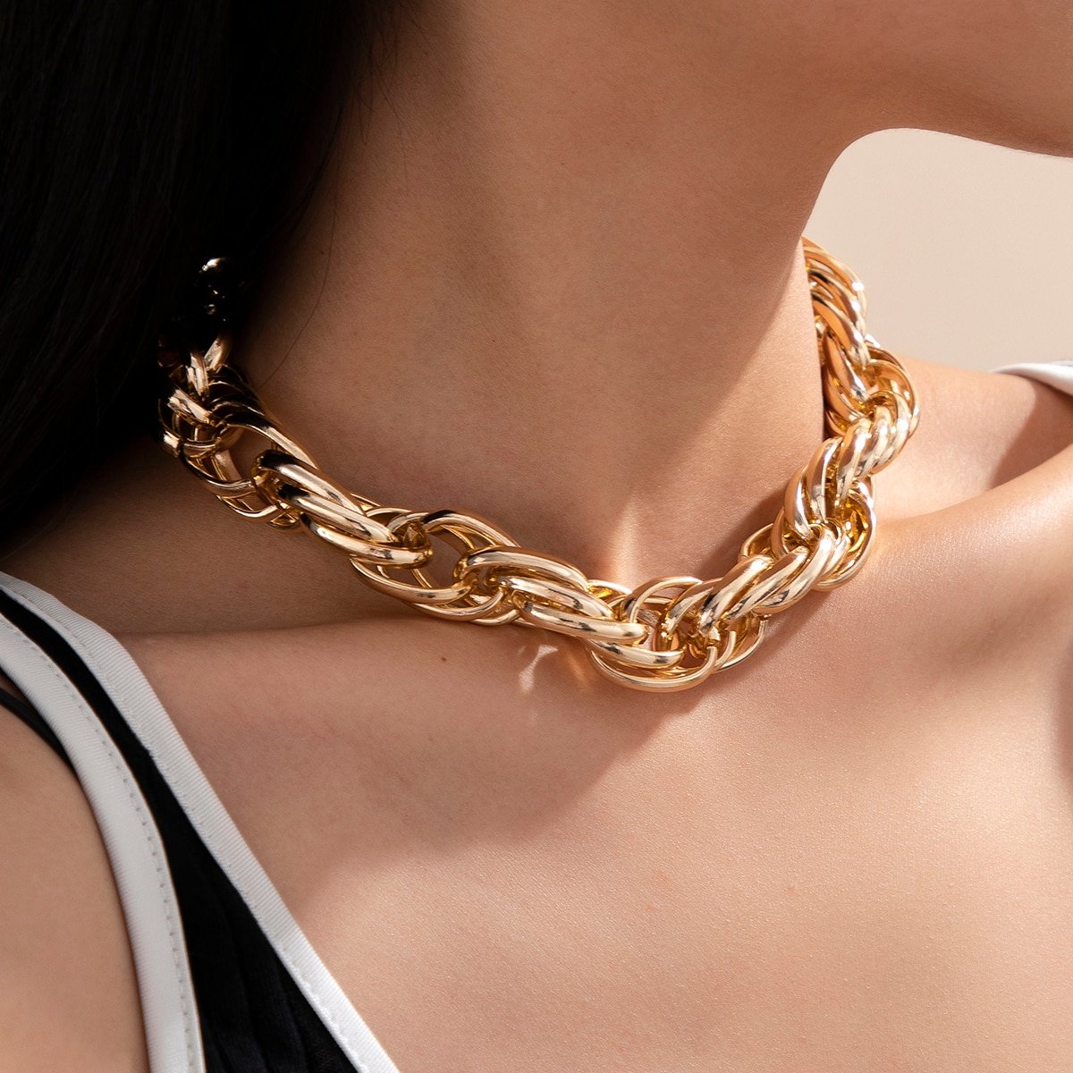 A Stylish Women's Thick Gold Chain Necklace wearing a thick gold chain necklace.