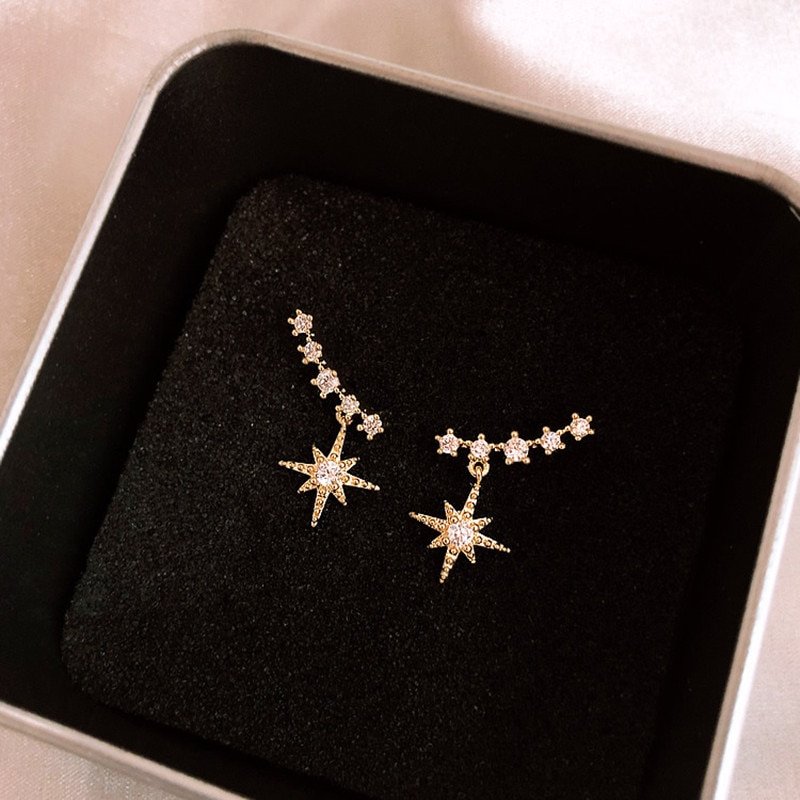 A pair of Women's Star Earrings perfect for women, presented in a box.