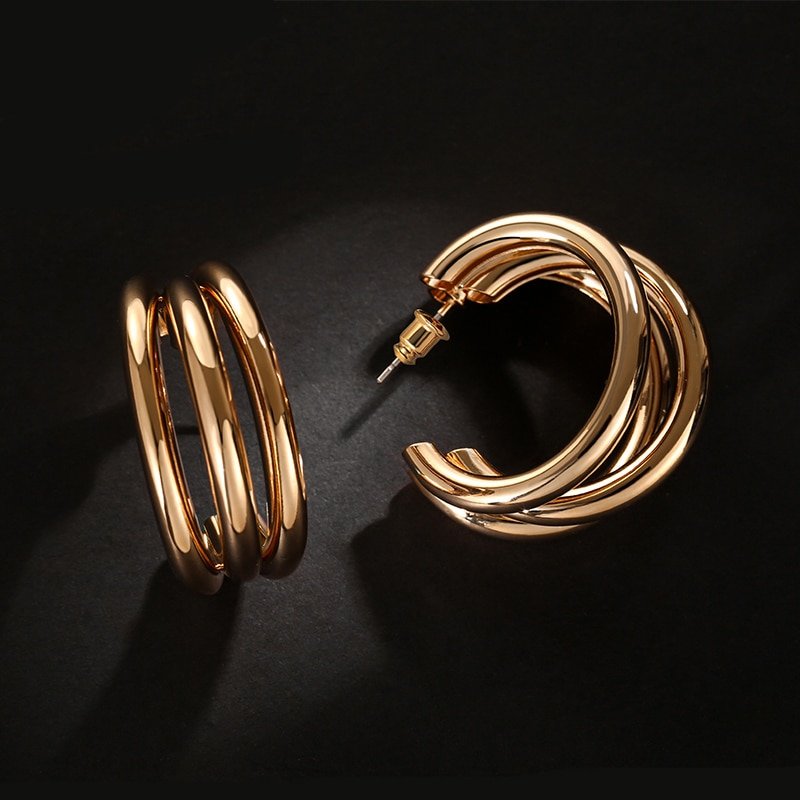 A pair of Women's Fashion Chunky Hoop Earrings displayed on a black background.