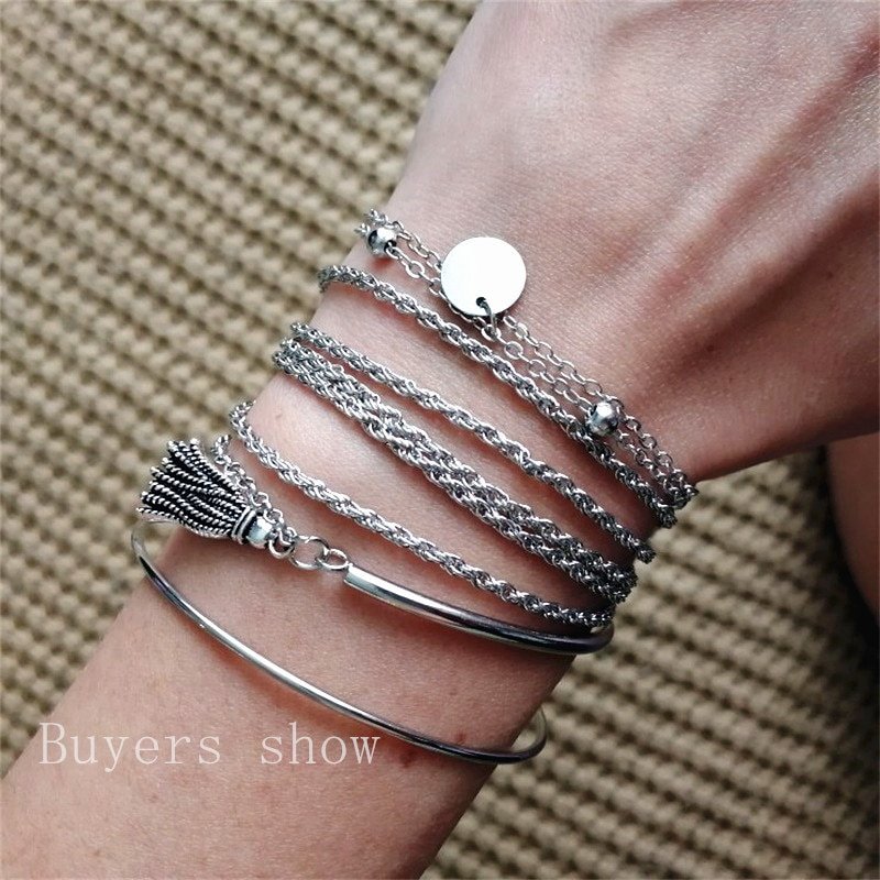 A wrist adorned with a Women's Bohemian Tassel Round Bracelet, showcasing the latest fashion trends.