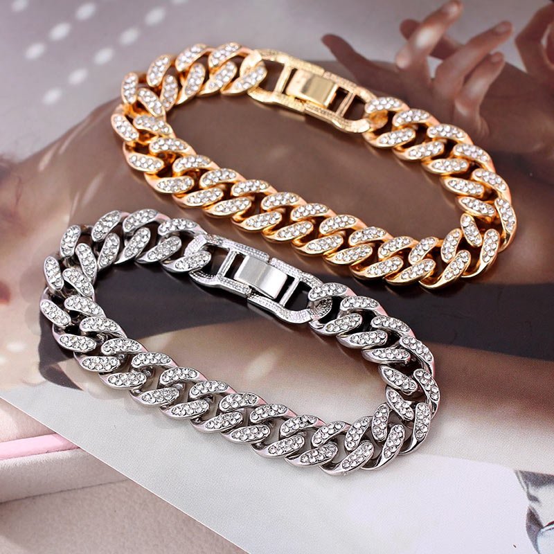 Two Women's Solid Link Chain Bracelets, one gold-toned and the other silver-toned, are showcased as the latest fashion accessory against a blurred background.