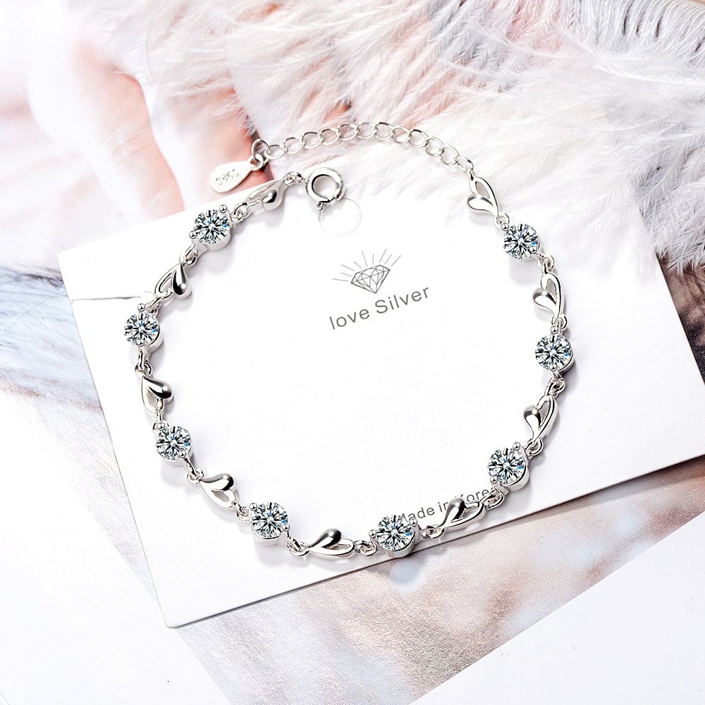 Women's 925 Sterling Silver Zircon Bracelet - Hearts Design with embedded crystals, a fashionable accessory displayed on a card with the text "love silver," epitomizes women's fashion style.