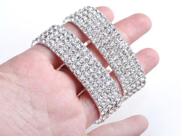A hand holding a Full Rhinestone Elastic Bracelet for Women, a fashion accessory, against a white background.