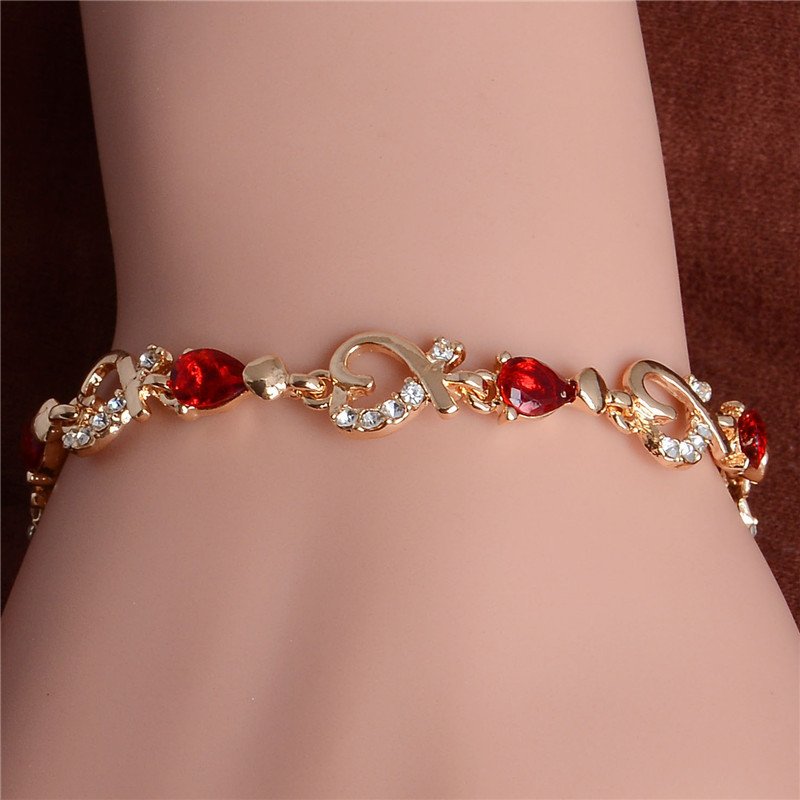 A Women's Fashion Colorful Bracelets with red gemstones and clear crystals, a staple in new fashion trends, worn on a wrist.