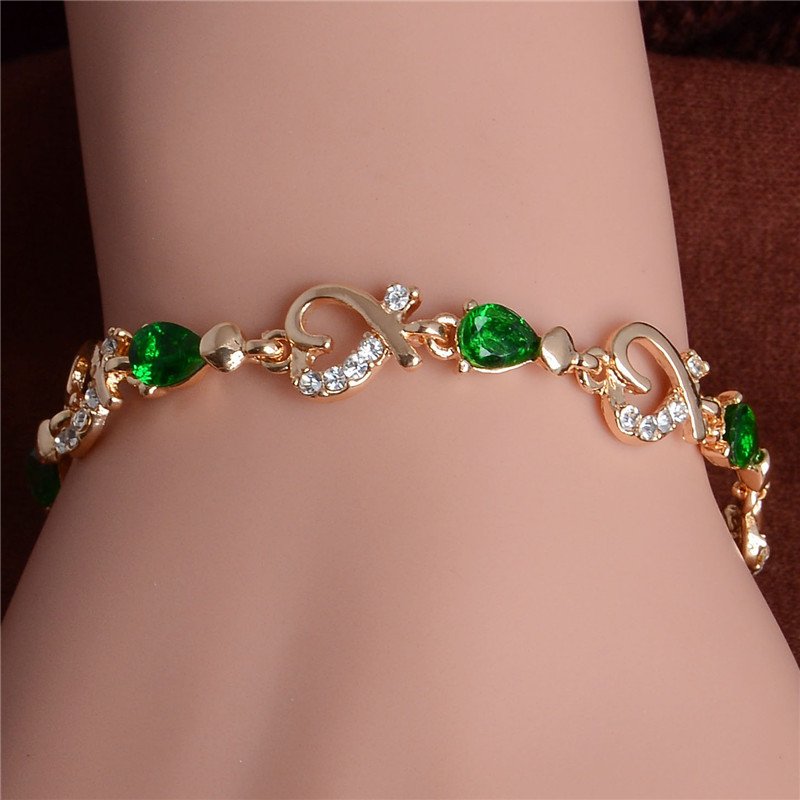 Women's Fashion Colorful Bracelets with green gemstones and diamond accents, a stunning women's fashion accessory, displayed on a mannequin's wrist.