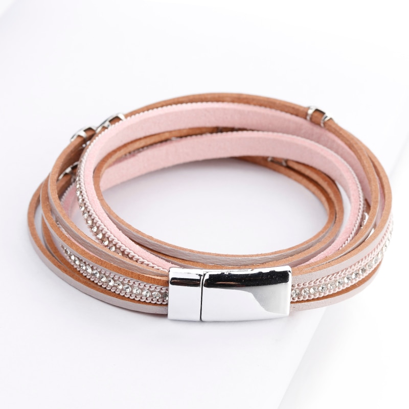 A Women's Boho Multilayered Wrap Bracelet with rhinestone accents and a silver magnetic clasp is a fashion accessory reflecting new fashion trends.