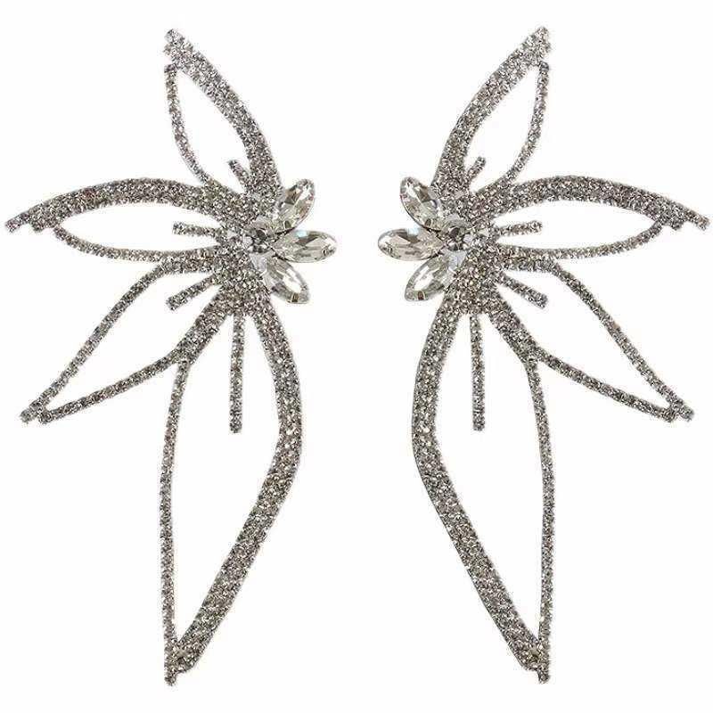 A pair of chic Maple Leaf zircon earrings, a fashionable accessory, on a white background.