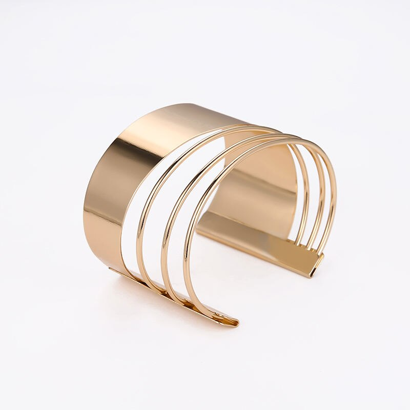 A Women's Bohemian Gold-Plated Geometric Cuff Bangle featuring a wide band and multiple curved, thin straps on a white background, epitomizing new fashion style.